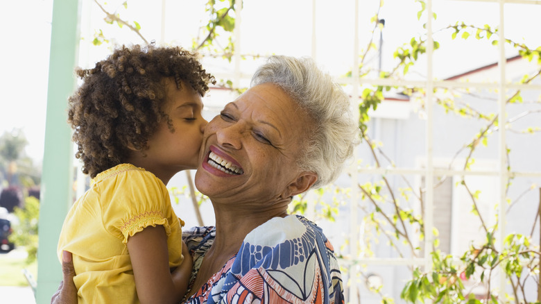 older woman holding younger girl