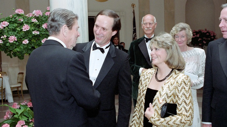 President Ronald Reagan Speaking with Dr. Robert Ballard and Marjorie Ballard in The White House Cross Hall at a Dinner for Prince Charles and Princess Diana, 11/9/1985
