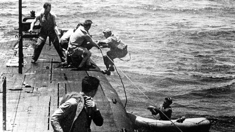 Submariners on the USS Tang pulling airmen from downed planes out of the water