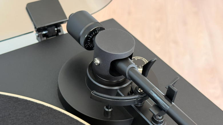 A stylus sits calibrated on a vinyl record