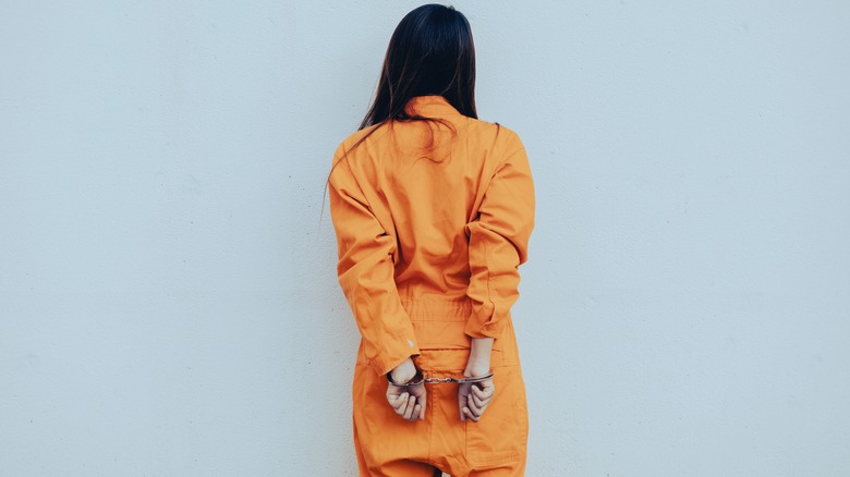 woman in handcuffs standing