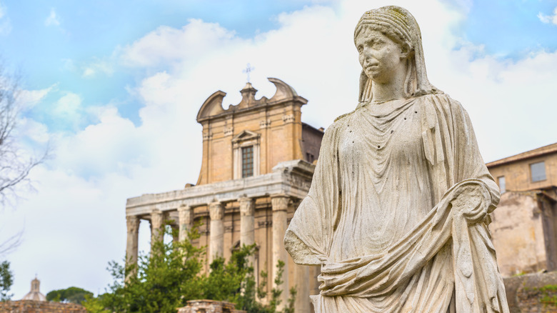 Vestal Virgin statue Roman ruin in background