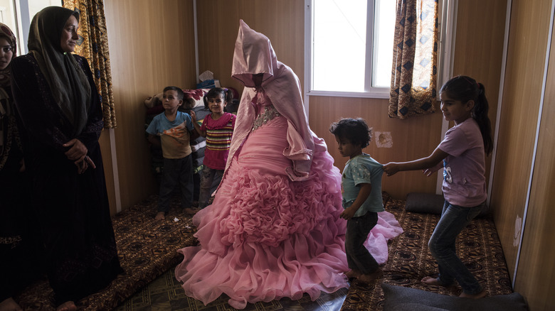 child bride during preparations pink dress