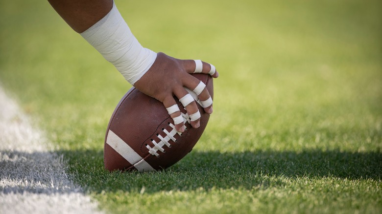 a football held by a player