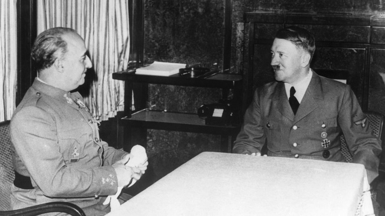 Adolf Hilter and Francisco Franco seated at a table