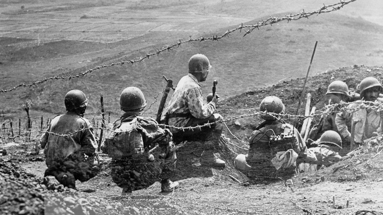 french soldier surveying viet minh positions at dien bien phu