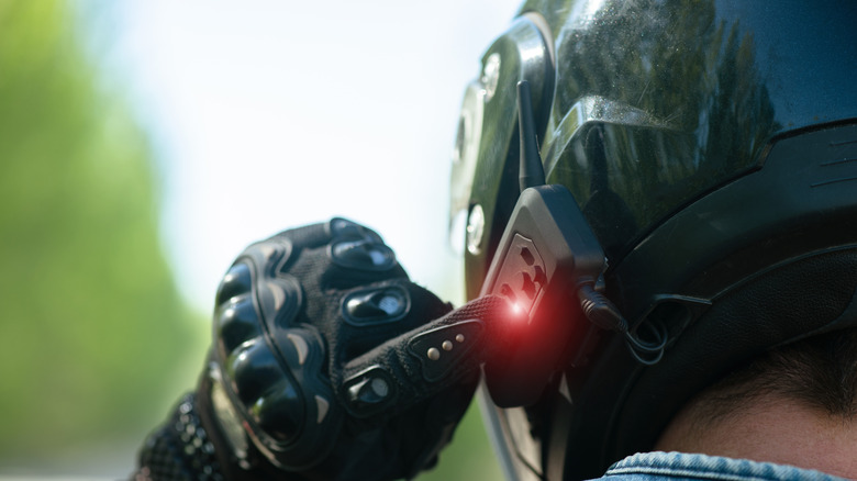 Motorcyclist using a phone pointed toward helmet