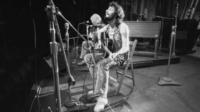 Cat Stevens sat performing live