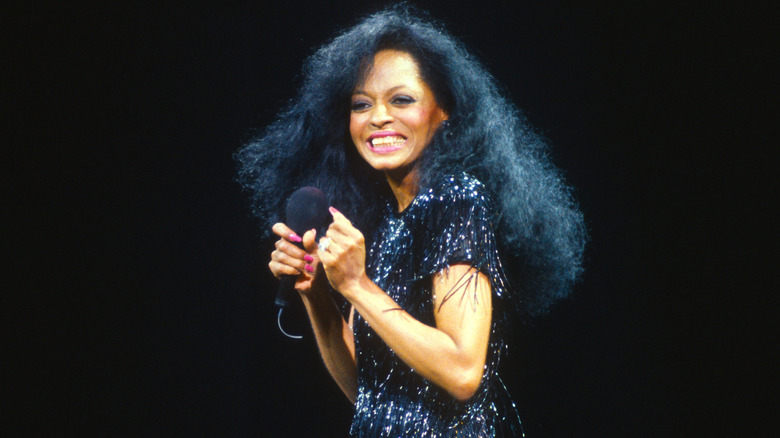 Diana ross smiling in sparkly dress on stage