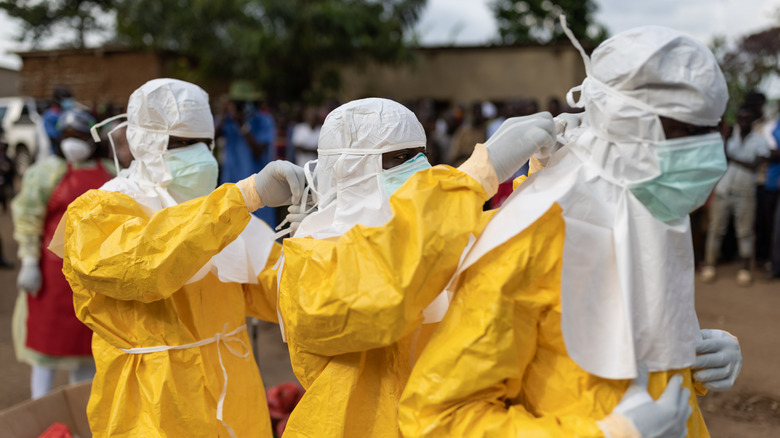 ugandan health workers in full ppe for suspected ebola
