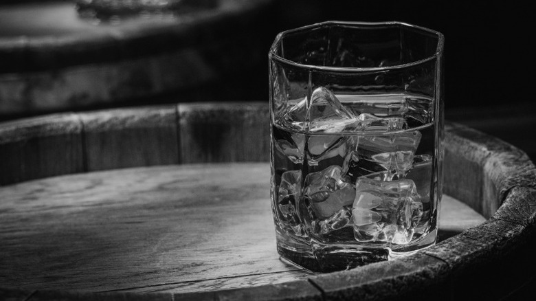 glass of whiskey on barrel