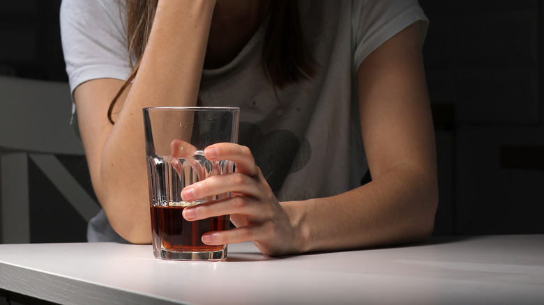 Woman holding alcohol