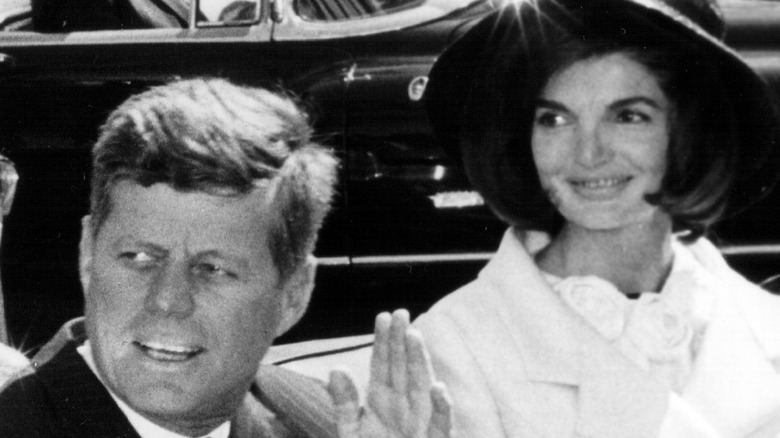 President John F Kennedy and Jackie Kennedy wave to well-wishers