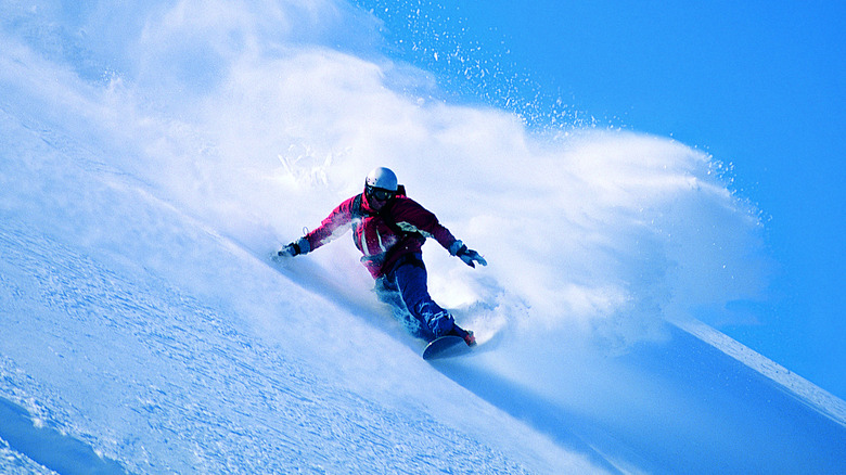 Snowboarder heading downhill