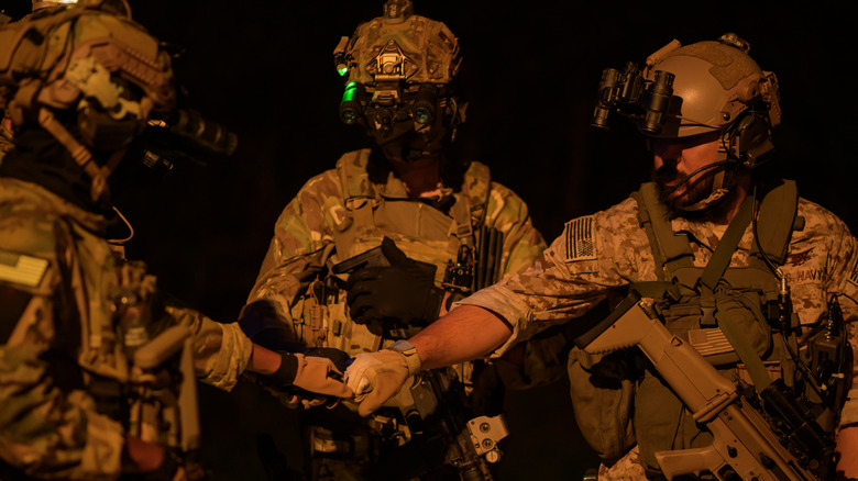 Soldiers fist-bumping each other