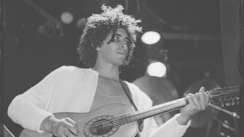 young Pat Smear playing guitar onstage 