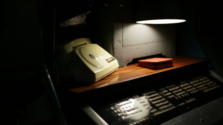 Disc phone on shadowy desk