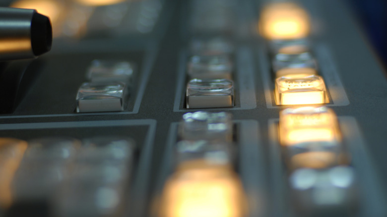 Closeup of control panel with vintage lit buttons.