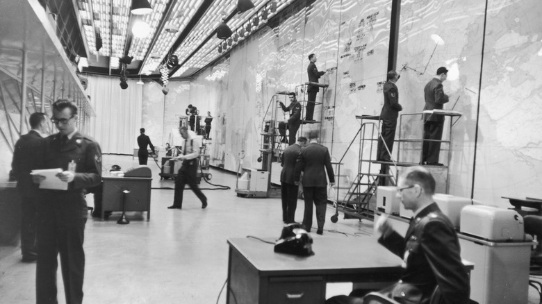 Interior view of intelligence officers at work in the control room of the United States Air Force Strategic Air Command Post, c. 1955