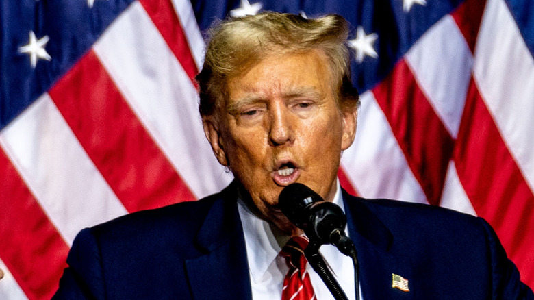 Donald Trump giving speech in front of American flag