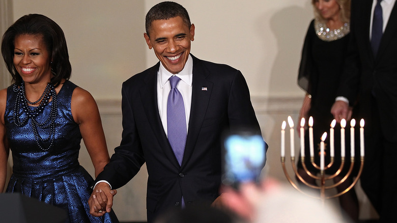 The obamas near a menorah