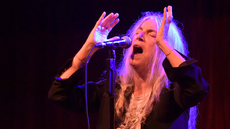 Patti Smith arms up singing