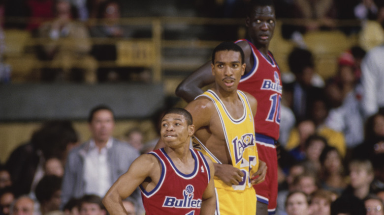 Billy Thompson flanked by Bogues and Bol