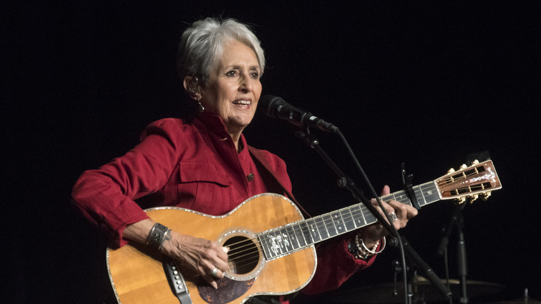 Joan Baez playing guitar