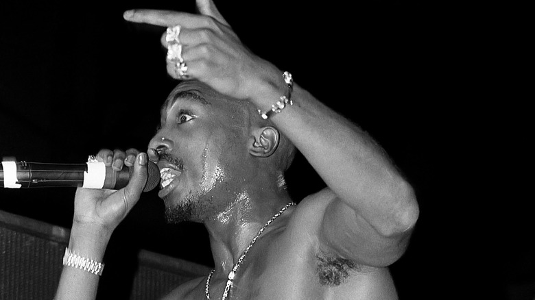 Tupac Shakur performing on stage