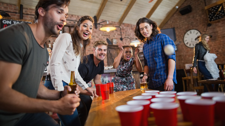 friends play beer pong 