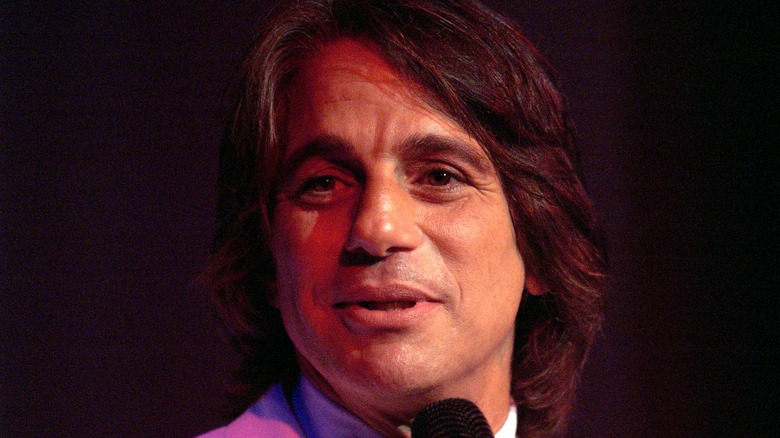 Tony Danza in white tuxedo with microphone