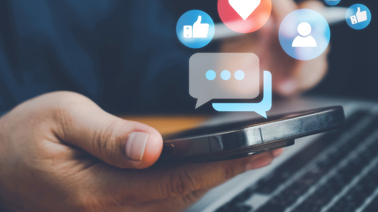 Social media app logos floating from a smartphone