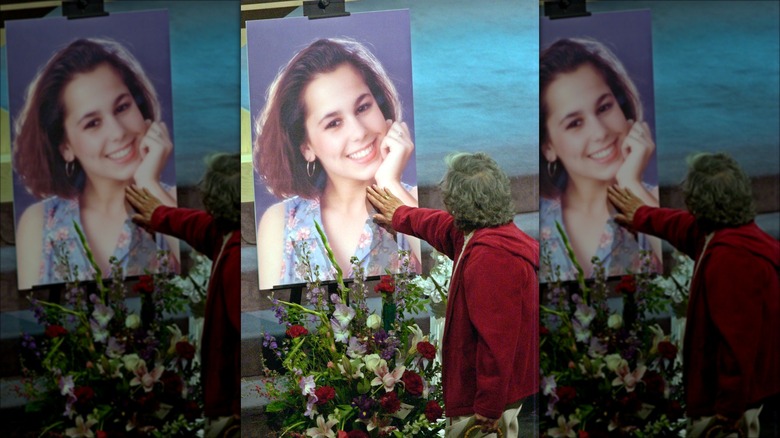 Woman touches memorial to Laci Peterson