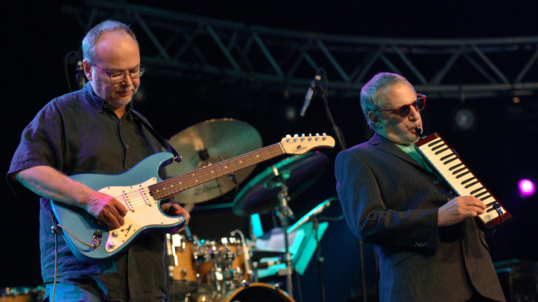 Walter Becker and Donald Fagan on stage with instruments
