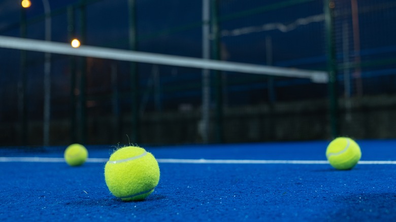 Tennis balls on blue court