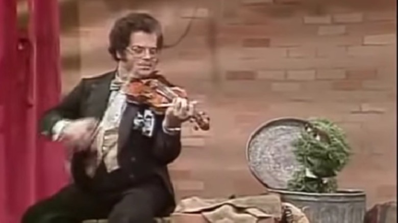 Itzhak Perlman with Oscar the Grouch playing violin