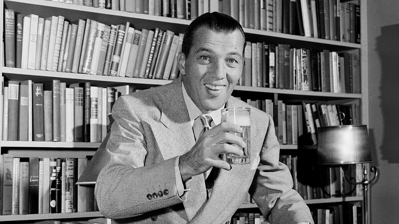 Ed Sullivan smiling and toasting