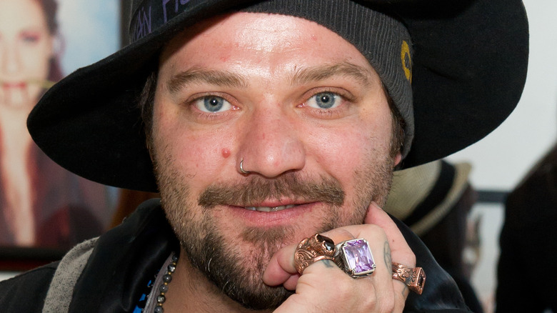 Bam Margera looking to camera smiling black hat beard