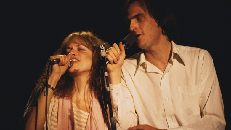 Carly Simon and James Taylor singing together on stage