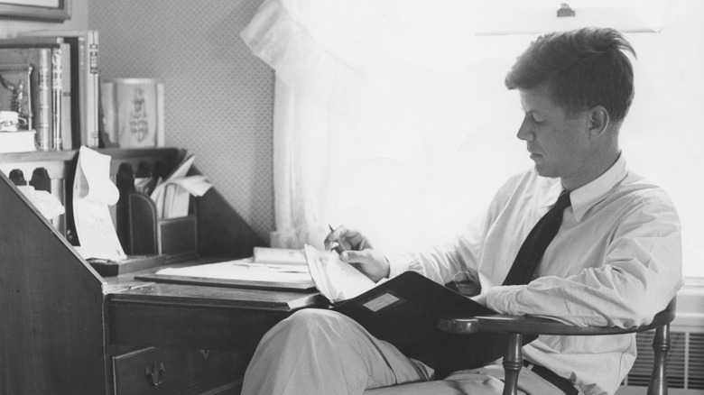 JFK reading at desk