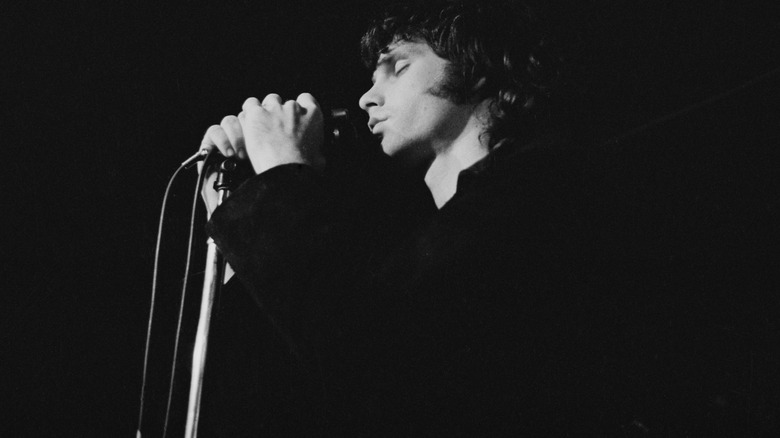 Jim Morrison singing into microphone