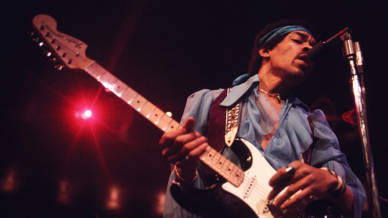 Jimi Hendrix playing in concert