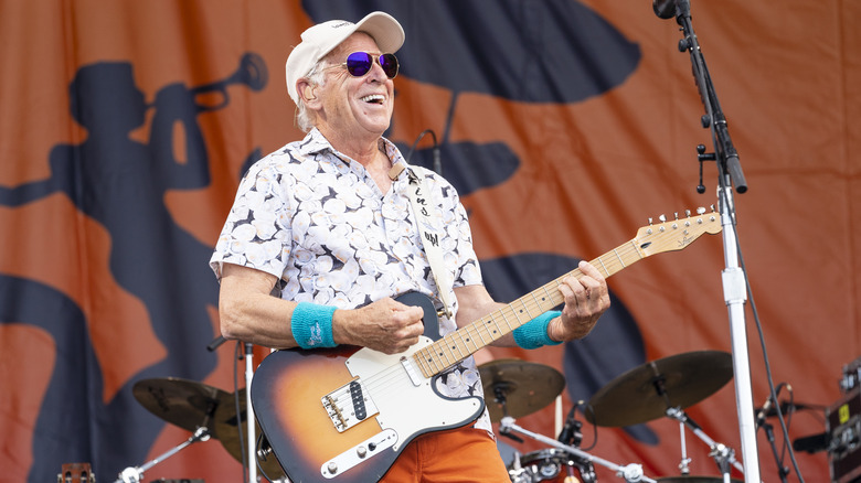 Jimmy Buffett stage guitar smiling