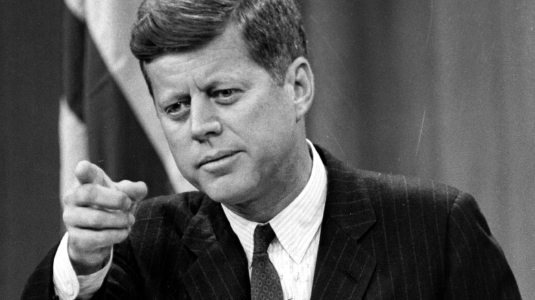 JFK looks out and points