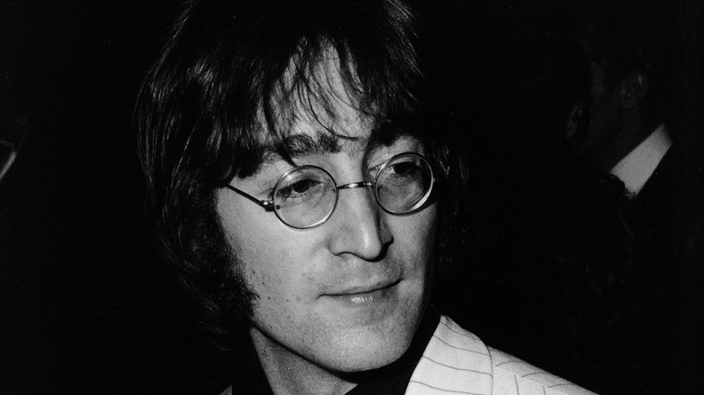 John Lennon in glasses looking to the left