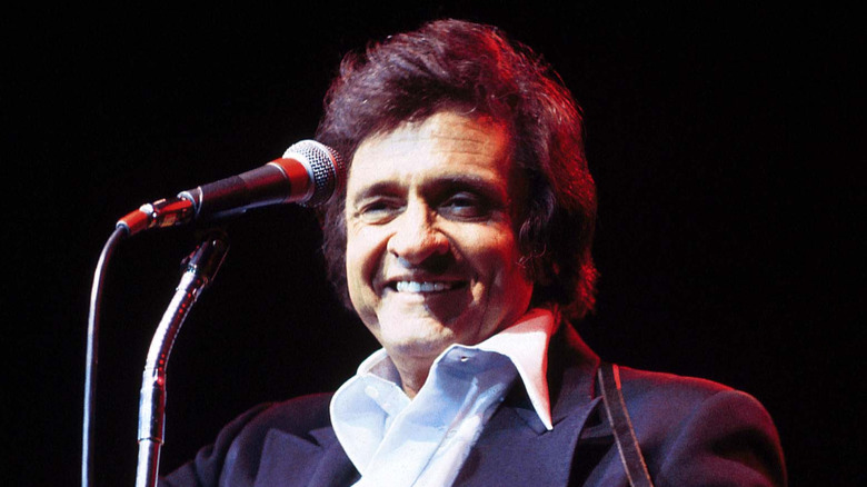 Johnny Cash smiling onstage in the 1970s