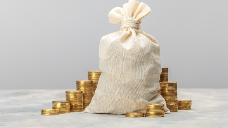 gold coins stacked and in a bag