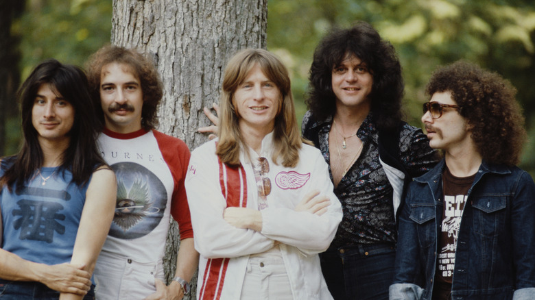 Journey smiling by a tree