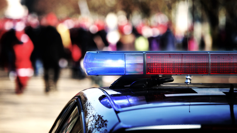 police car with pedestrians 