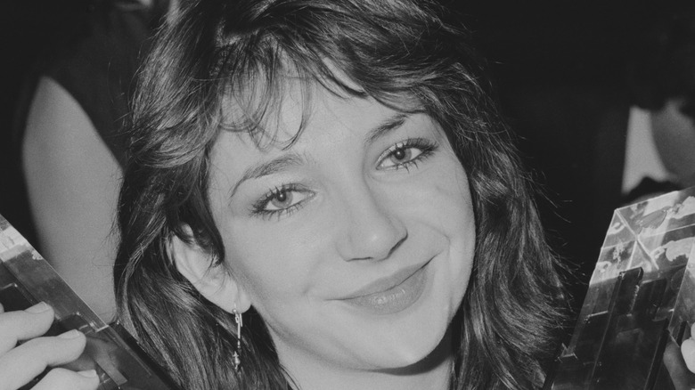 Kate Bush holding two awards